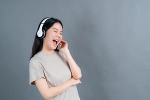 Young Asian woman listening to music with headphones
