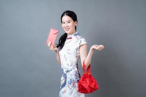 Asian woman wear Chinese traditional dress with red envelope or red packet photo