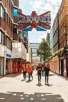 London, England, UK - SEP 2, 2019 - People walking for shopping in Carnaby Street. Carnaby Street is a pedestrianised shopping street in Soho in the City of Westminster, Central London. photo