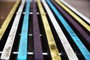 Colorful dirty painted bench planks bokeh background photo