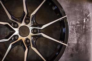 Luxury chrome alloy wheel in close-up as an automotive background.  Close up shot of a new car rim. photo