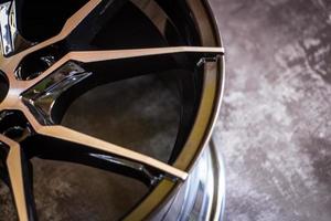 Luxury chrome alloy wheel in close-up as an automotive background.  Close up shot of a new car rim. photo
