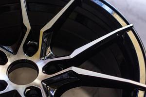Luxury chrome alloy wheel in close-up as an automotive background.  Close up shot of a new car rim. photo