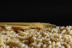 Yellow long spaghetti on a rustic background. Yellow italian pasta. Long spaghetti. Raw spaghetti bolognese. Raw spaghetti. Food background concept. Italian food and menu concept. photo