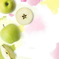 Fresh green apples on white background with watercolor strokes creative layout with copy space photo
