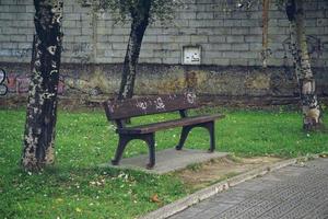 Empty wooden bench on the street photo