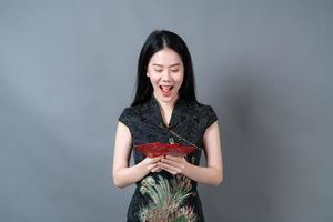 Asian woman wear Chinese traditional dress with red envelope or red packet photo