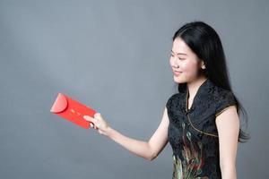 Asian woman wear Chinese traditional dress with red envelope or red packet photo