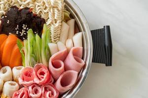 Budae Jjigae or Budaejjigae or Army stew or Army base stew. It is loaded with Kimchi, spam, sausages, ramen noodles and much more photo