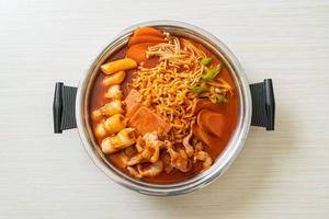 Budae Jjigae or Budaejjigae or Army stew or Army base stew. It is loaded with Kimchi, spam, sausages, ramen noodles and much more photo
