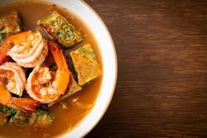 Sour soup made of Tamarind Paste with Shrimps and Vegetable Omelet photo