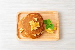 Apple pancake or apple crepe with cinnamon powder photo