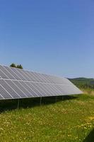 Solar Power Station on the summer flowering Meadow photo