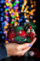 Hand holding Christmas bauble photo