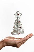 Hand holding Christmas decoration photo