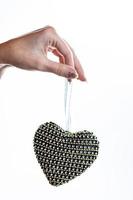 Hand holding heart shaped decoration