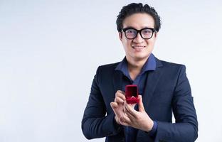 Portrait of Asian businessman holding a marriage proposal photo