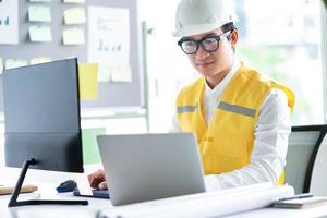 Asian engineer working at computer photo