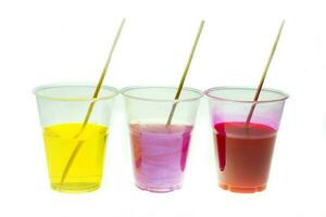 Mixing color epoxy resin in plastic cup for casting Stabilizing wood and pine cone hybrid at white background photo