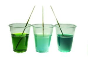 Mixing color epoxy resin in plastic cup for casting Stabilizing wood and pine cone hybrid at white background photo