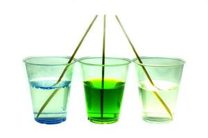 Mixing color epoxy resin in plastic cup for casting Stabilizing wood and pine cone hybrid at white background photo