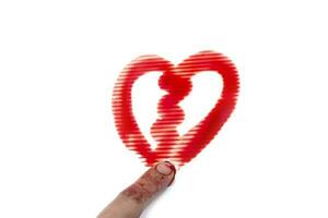 Use your finger to draw a heart by bloody on white background photo