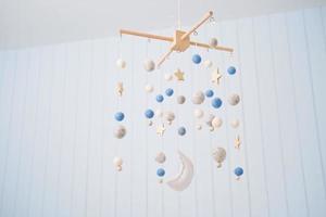 Baby crib mobile. Toys above the baby crib. Hanging soft balls for the child. photo