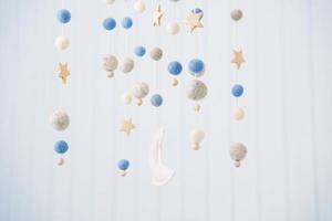 Baby crib mobile. Toys above the baby crib. Hanging soft balls for the child. photo