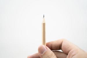 Hand holding a wooden pencil on white background. Designer concept. Selective focus. photo
