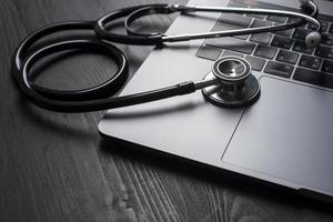 Stethoscope on laptop close up photo