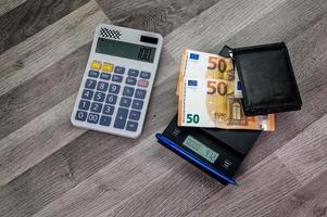 euro banknotes on top of a scale with nearby calculator photo