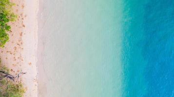 Aerial view of Beach with shade emerald blue water and wave foam on tropical sea photo