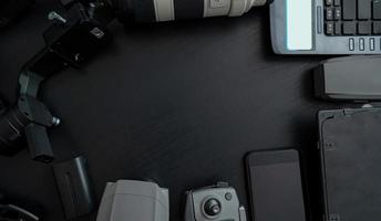 Top view of tools professional photographer and video with camera accessory on wooden background photo