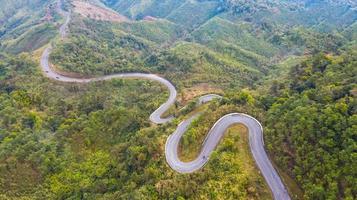 Aerial top view of a road in the forest photo