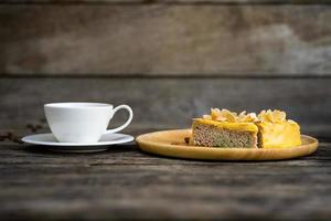 Cup of coffee with dessert on a wooden table photo