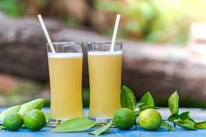 Lemon juice on a wooden table photo