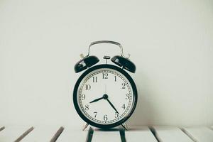 Black clock on table with copy space photo