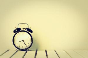 Black clock on table with copy space photo