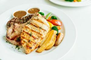 Chicken breast and Pork chop with beef meat steak and vegetable photo