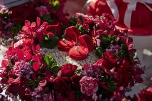 Pair of wedding rings on red rose photo