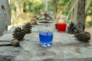 Epoxy resin Red yellow blue collor in cup for casting Stabilizing wood hybrid, abstract art background photo