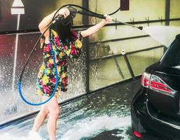 Girl washing a car photo