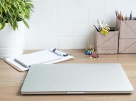 Laptop with office supplies on the table photo