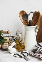 Kitchen utensils, tools and dishware on on the background white tile wall photo