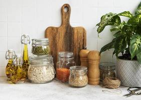 Kitchen utensils, tools and dishware on on the background white tile wall photo