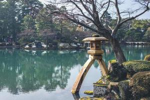 The Kotoji Toro, a two legged stone lantern at Kanazawain, Japan photo