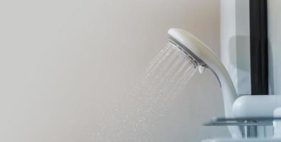 Close up of Water flowing from shower in the bathroom photo