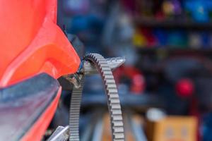 Automobile mechanic repairing motorcycle in bike repair shop photo