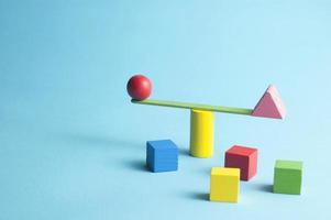 Minimal concept with a stick swingscale and colorful geometric figures photo