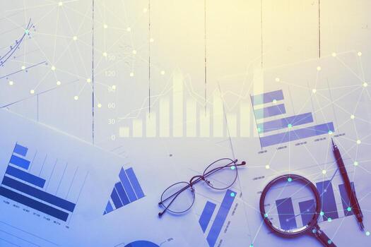 Magnifying glass and documents with analytics data lying on table,selective focus photo